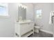 Bright bathroom with a large mirror, white cabinets, and sleek fixtures at 2536 Brookshire Ave, Winter Park, FL 32792