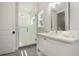 Bathroom featuring a glass shower door, white cabinets, and modern fixtures at 2536 Brookshire Ave, Winter Park, FL 32792