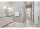 Modern bathroom with dual sinks, vanity, and glass shower adjacent to a hallway to the bedroom at 2536 Brookshire Ave, Winter Park, FL 32792