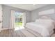 Serene bedroom with neutral tones, a sliding glass door to the backyard, and wood-look floors at 2536 Brookshire Ave, Winter Park, FL 32792