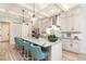 Bright kitchen features an island with seating, granite counters, pendant lights, and stylish cabinets at 2536 Brookshire Ave, Winter Park, FL 32792