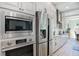 Modern kitchen with stainless steel appliances, including microwave and refrigerator, framed by stylish cabinetry at 2536 Brookshire Ave, Winter Park, FL 32792