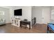A living room featuring hardwood floors, a piano, television, and a pool table at 2536 Brookshire Ave, Winter Park, FL 32792