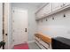 Convenient mudroom equipped with a built-in bench, storage baskets, coat hooks, and access to the garage at 2536 Brookshire Ave, Winter Park, FL 32792