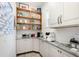 Well-organized pantry featuring open shelving, white cabinetry, ample counter space, and modern appliances at 2536 Brookshire Ave, Winter Park, FL 32792