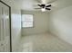 Bedroom featuring tile floors, a ceiling fan with lighting, and a window at 2751 L B Mcleod Rd # 2751, Orlando, FL 32805