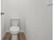 Powder room includes hardwood-style flooring and a modern toilet at 2933 Wild Olive Dr, St Cloud, FL 34772