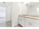 Bright bathroom featuring a granite-topped double vanity and tile flooring at 2933 Wild Olive Dr, St Cloud, FL 34772