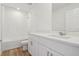 Bathroom features a shower over tub, vanity with storage, and wood-look flooring at 2933 Wild Olive Dr, St Cloud, FL 34772