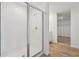 Modern bathroom showcases tiled shower with glass door and wood-look floors at 2933 Wild Olive Dr, St Cloud, FL 34772