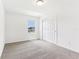 A bright bedroom featuring plush carpeting, a window, and sliding closet doors at 2933 Wild Olive Dr, St Cloud, FL 34772