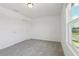 Bright bedroom with plush carpeting, natural light from the window, and a closet at 2933 Wild Olive Dr, St Cloud, FL 34772