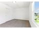 A bright bedroom with carpeting and a large window at 2933 Wild Olive Dr, St Cloud, FL 34772