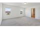 Bright bedroom includes neutral carpet and two windows with neighborhood views at 2933 Wild Olive Dr, St Cloud, FL 34772