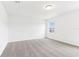 Bright bedroom with neutral carpet, a window, and white walls, creating a calm space at 2933 Wild Olive Dr, St Cloud, FL 34772