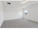 Bright bedroom features neutral carpet, light walls, and a window allowing for natural light at 2933 Wild Olive Dr, St Cloud, FL 34772