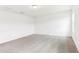 Empty bedroom with neutral carpet, a window, and white walls, creating a bright space at 2933 Wild Olive Dr, St Cloud, FL 34772