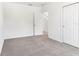 Empty bedroom with carpet, a window, and two doors leading to other parts of the home at 2933 Wild Olive Dr, St Cloud, FL 34772