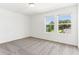 A bright bedroom featuring plush carpeting and natural light at 2933 Wild Olive Dr, St Cloud, FL 34772