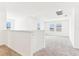 Spacious bonus room with neutral carpet, natural light from windows, and open to the staircase at 2933 Wild Olive Dr, St Cloud, FL 34772