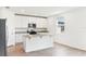 Well-lit kitchen with white cabinets, granite countertops, and stainless steel appliances at 2933 Wild Olive Dr, St Cloud, FL 34772