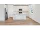Modern kitchen with white cabinets, stainless steel appliances, and a kitchen island at 2933 Wild Olive Dr, St Cloud, FL 34772