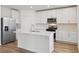 Modern kitchen featuring white cabinetry, stainless steel appliances, and a center island with seating at 2933 Wild Olive Dr, St Cloud, FL 34772