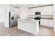 Modern kitchen with granite counters, stainless appliances, and a central island at 2933 Wild Olive Dr, St Cloud, FL 34772
