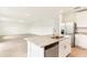 Open kitchen view featuring a central island with granite countertops and stainless steel appliances at 2933 Wild Olive Dr, St Cloud, FL 34772
