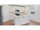 Well-lit kitchen with a center island, stainless steel appliances, and white cabinets at 2933 Wild Olive Dr, St Cloud, FL 34772
