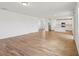 Spacious open-concept living area featuring wood-look tile flooring and an adjacent kitchen at 2933 Wild Olive Dr, St Cloud, FL 34772