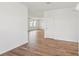 Spacious living room featuring wood-look tile floors, white walls, and recessed lighting at 2933 Wild Olive Dr, St Cloud, FL 34772