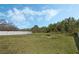 Expansive backyard featuring lush grass, mature trees, and privacy fence at 3275 Deer Lick Ct, Kissimmee, FL 34746