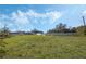 Large backyard featuring lush grass, mature trees, and a white privacy fence at 3275 Deer Lick Ct, Kissimmee, FL 34746