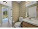 Bathroom with sink, toilet, and access to an outdoor pool at 3275 Deer Lick Ct, Kissimmee, FL 34746