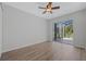 Bright bedroom with ceiling fan, wood floors, and sliding glass doors to the lanai at 3275 Deer Lick Ct, Kissimmee, FL 34746