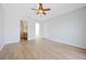 Bedroom with laminate floors, ceiling fan, and access to the bathroom at 3275 Deer Lick Ct, Kissimmee, FL 34746