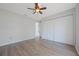 Bedroom features wood floors, ceiling fan, and closet at 3275 Deer Lick Ct, Kissimmee, FL 34746