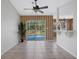 Dining area with a sliding glass door overlooking the pool, complemented by tile floors and neutral decor at 3275 Deer Lick Ct, Kissimmee, FL 34746