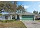 Single-story home with a two-car garage, arched windows, and a well-maintained front lawn at 3275 Deer Lick Ct, Kissimmee, FL 34746
