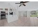 Open-concept living area connecting the kitchen and living room, featuring tile floors and bright lighting at 3275 Deer Lick Ct, Kissimmee, FL 34746