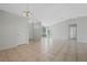 Bright living room with tile floors, neutral walls, and a decorative chandelier at 3275 Deer Lick Ct, Kissimmee, FL 34746