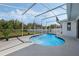 Sparkling in-ground pool with a screened enclosure and a spacious patio area, perfect for outdoor relaxation at 3275 Deer Lick Ct, Kissimmee, FL 34746