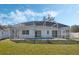 A view of the screened in pool and patio with plenty of green space at 3275 Deer Lick Ct, Kissimmee, FL 34746