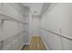 Spacious walk-in closet featuring shelving and a laminate wood floor at 3275 Deer Lick Ct, Kissimmee, FL 34746