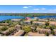 Beautiful aerial view showcasing a community near a picturesque lake, surrounded by lush greenery and landscapes, marked by red pin at 3332 Robert Trent Jones Dr # 20703, Orlando, FL 32835