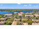 Scenic aerial view of a lake community featuring multiple buildings with a red pin for marking a property at 3332 Robert Trent Jones Dr # 20703, Orlando, FL 32835