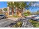Condo building exterior, parking area, sidewalks, manicured landscaping, and shade trees at 3332 Robert Trent Jones Dr # 20703, Orlando, FL 32835