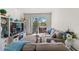 Bright living room featuring comfortable seating and a sliding door to a private balcony with outdoor views at 3332 Robert Trent Jones Dr # 20703, Orlando, FL 32835