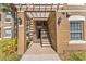 Stairway under a pergola with lamps and apartment numbers in a condo building at 3332 Robert Trent Jones Dr # 20703, Orlando, FL 32835